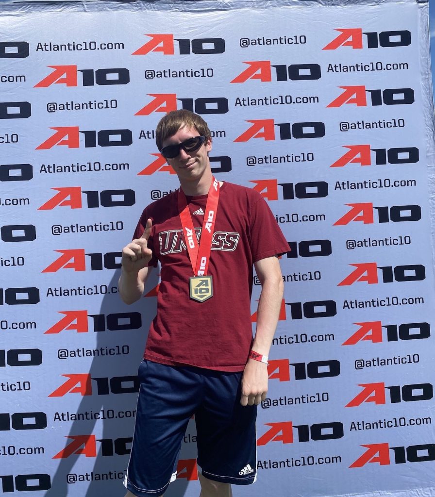 Male athlete poses after winning gold medal