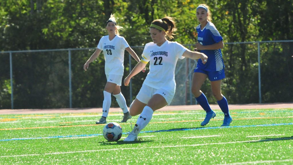 Female soccer player kicking a soccer ball