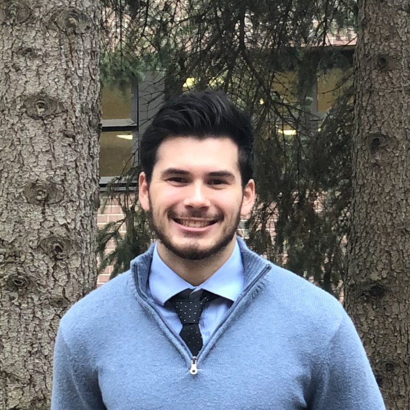 Man posing for photo with trees in background